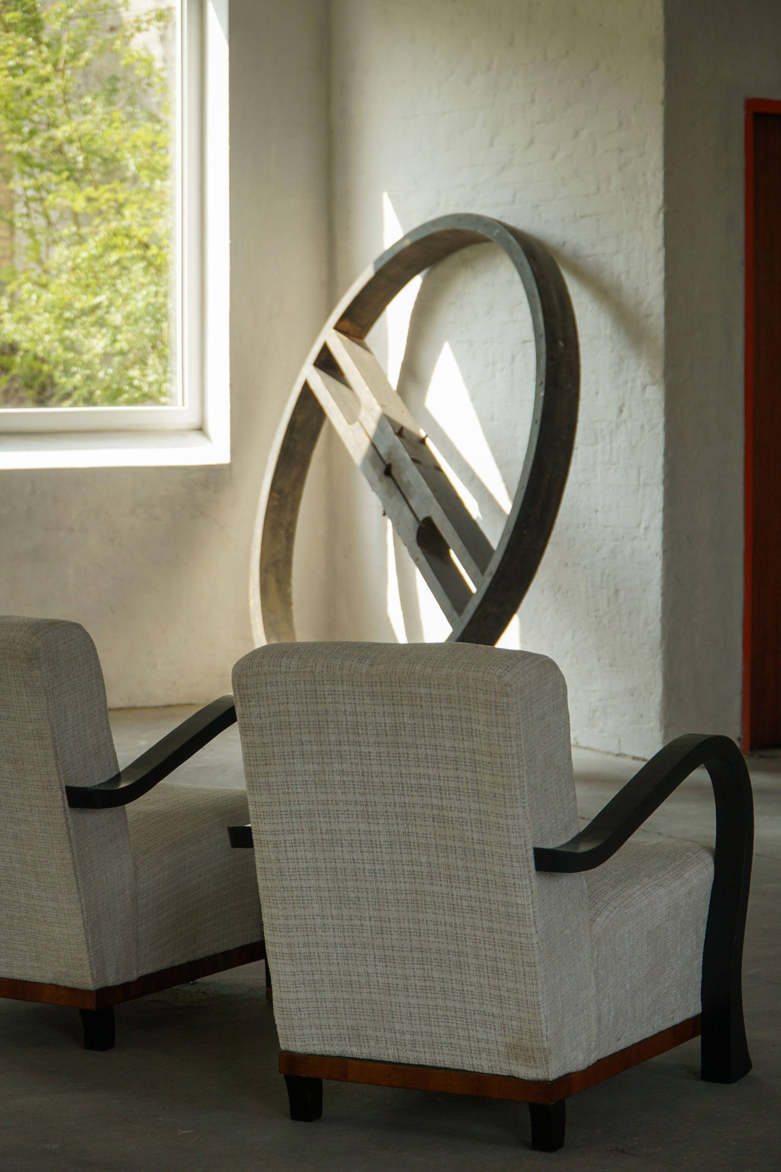 A pair of Swedish Art Deco lounge chairs with curved armrests, 1930s.