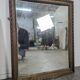Miroir Napoléon III à cadre en bois sculpté et doré