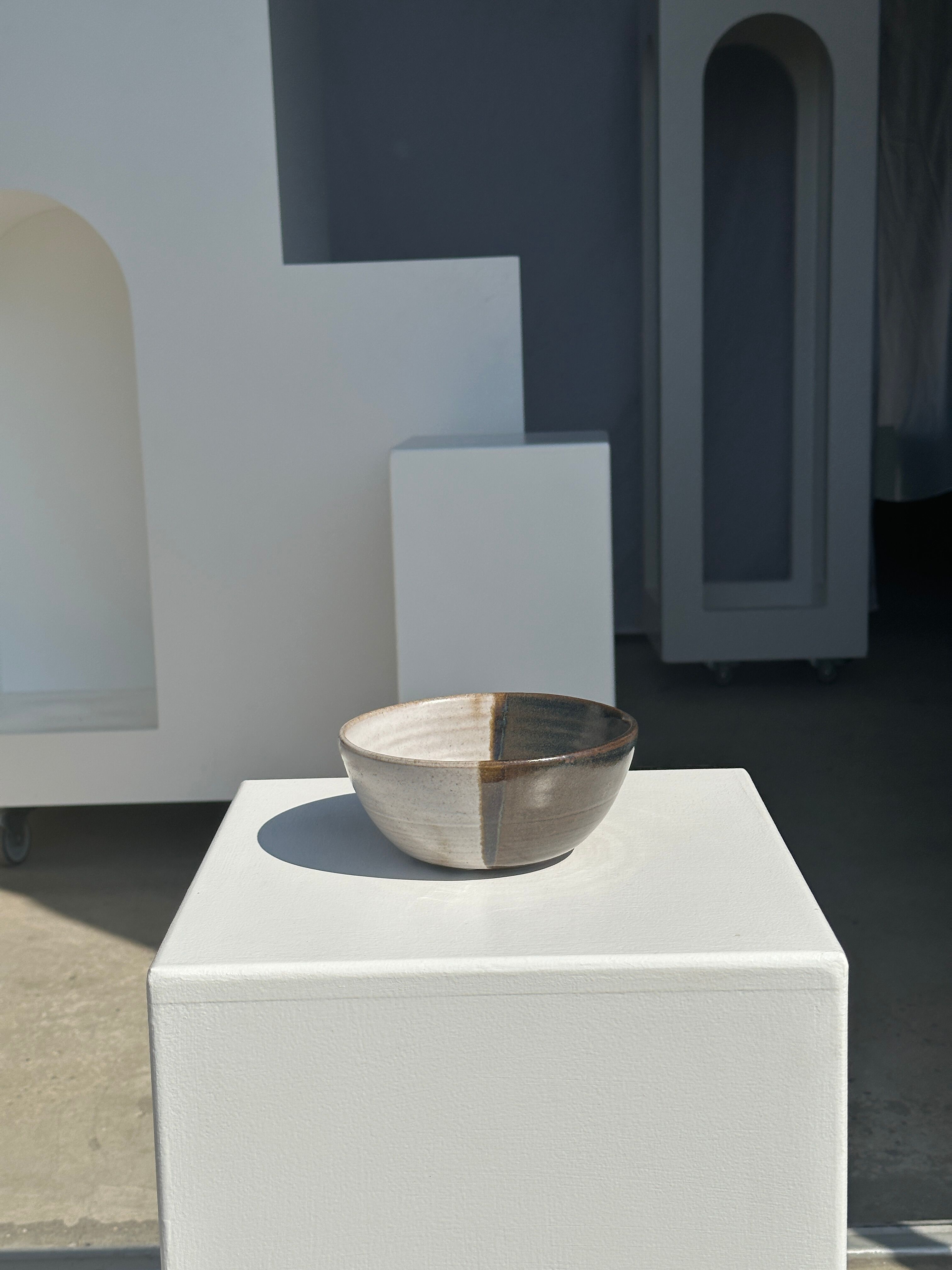 White and glossy brown two-tone ceramic bowl, matt earth