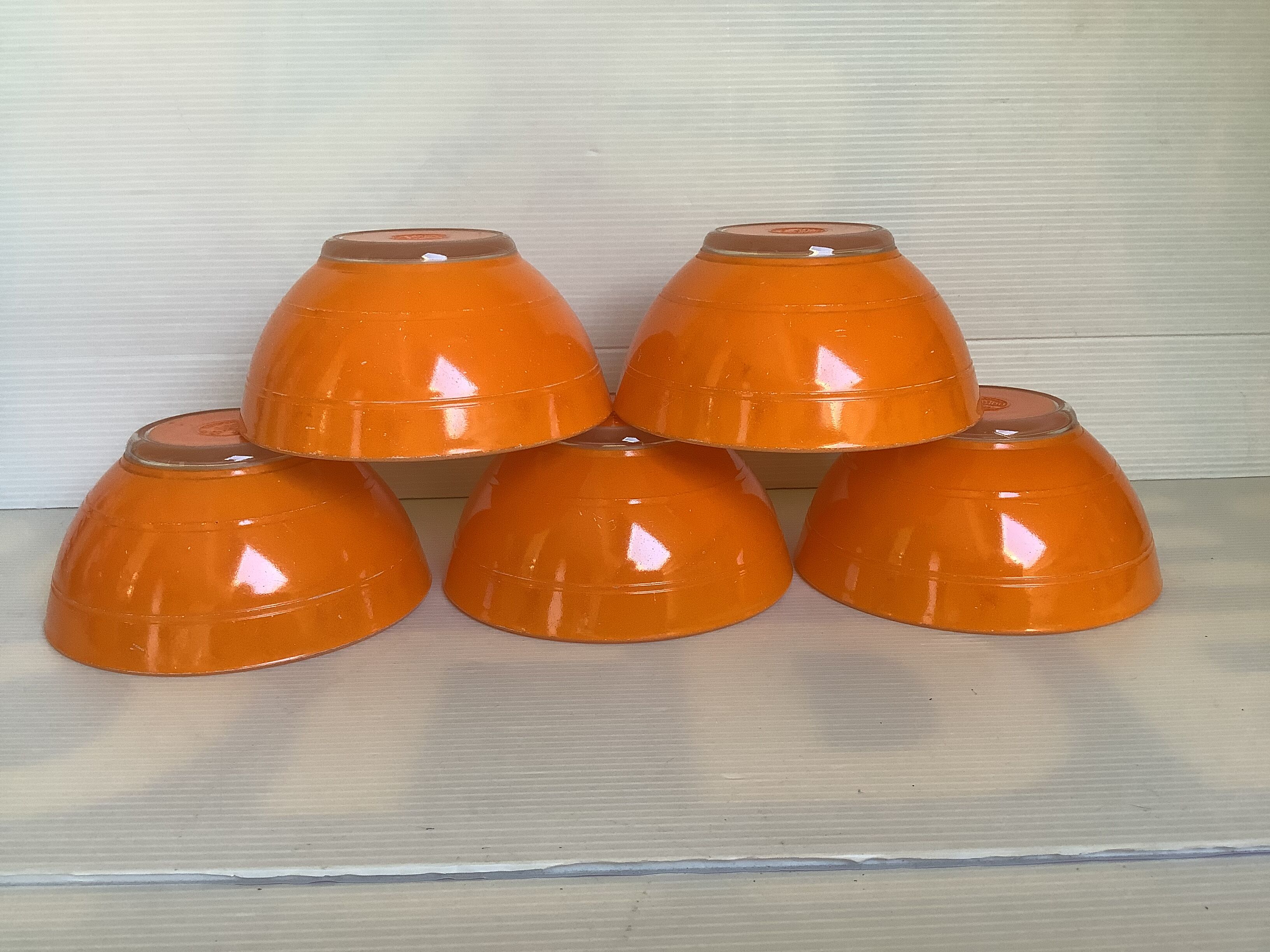 Five old orange duralex bowls