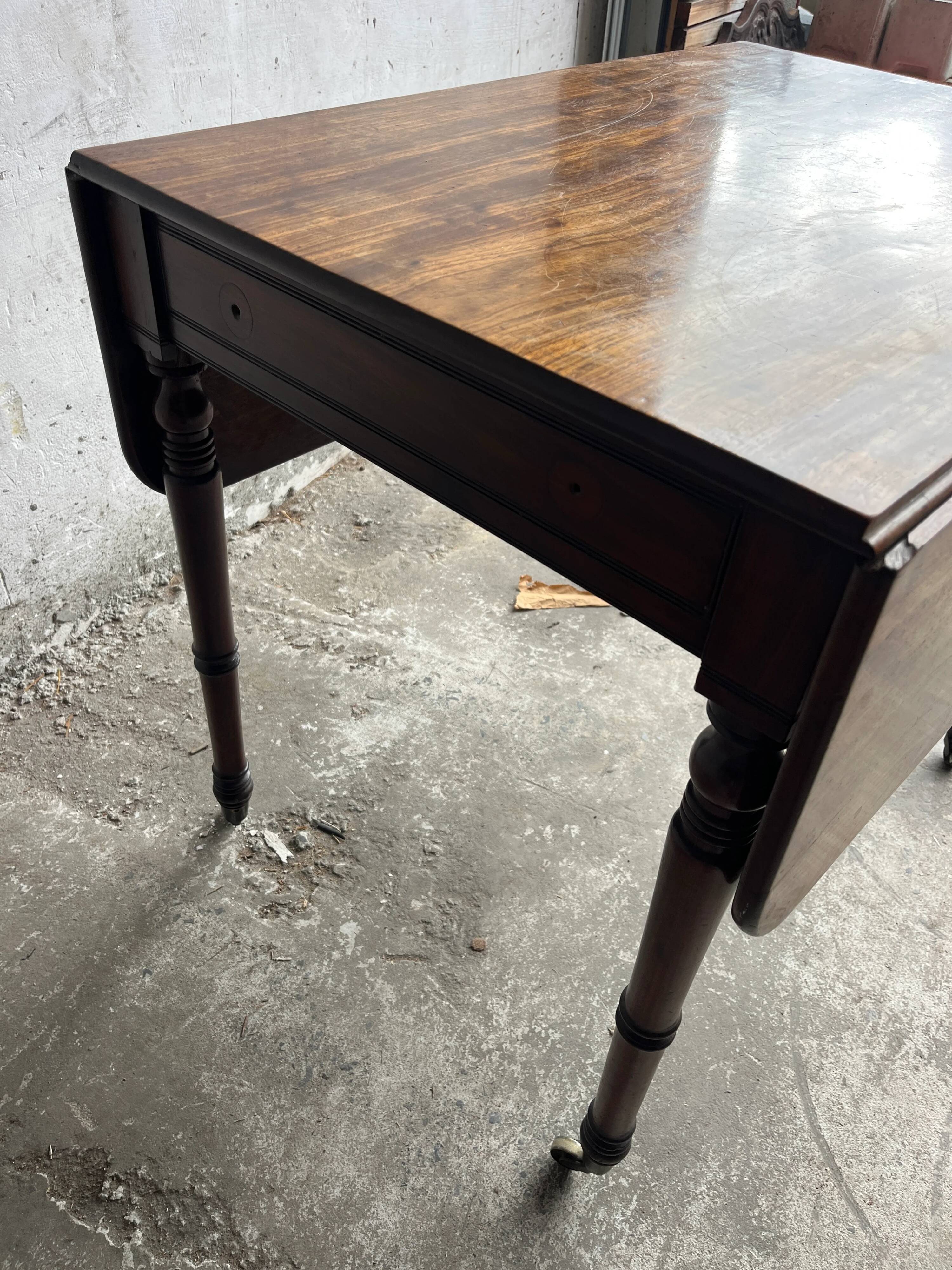 Antique drop-leaf side table on wheels