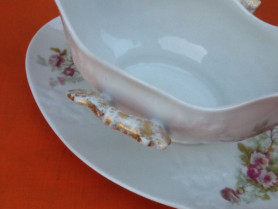 Sauce boat on dormant white porcelain, floral decoration
