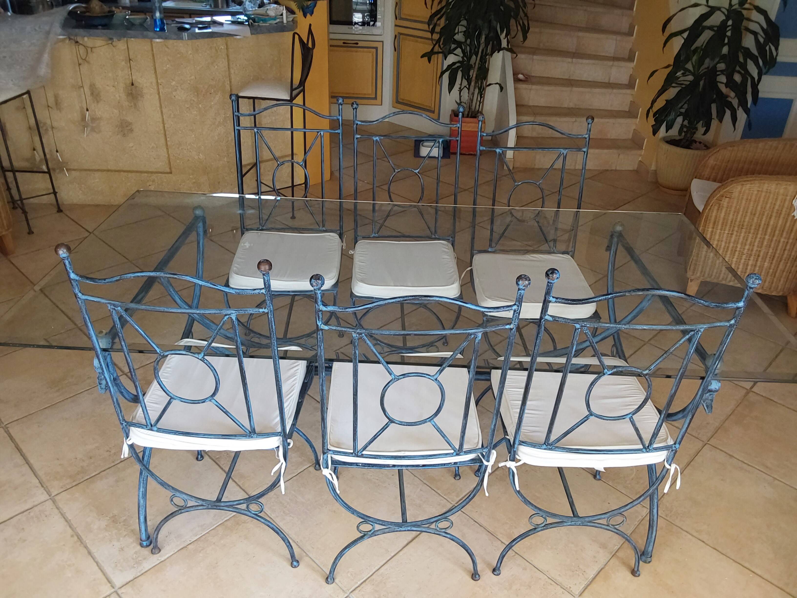 Wrought iron and bevelled glass table with 6 matching chairs.
