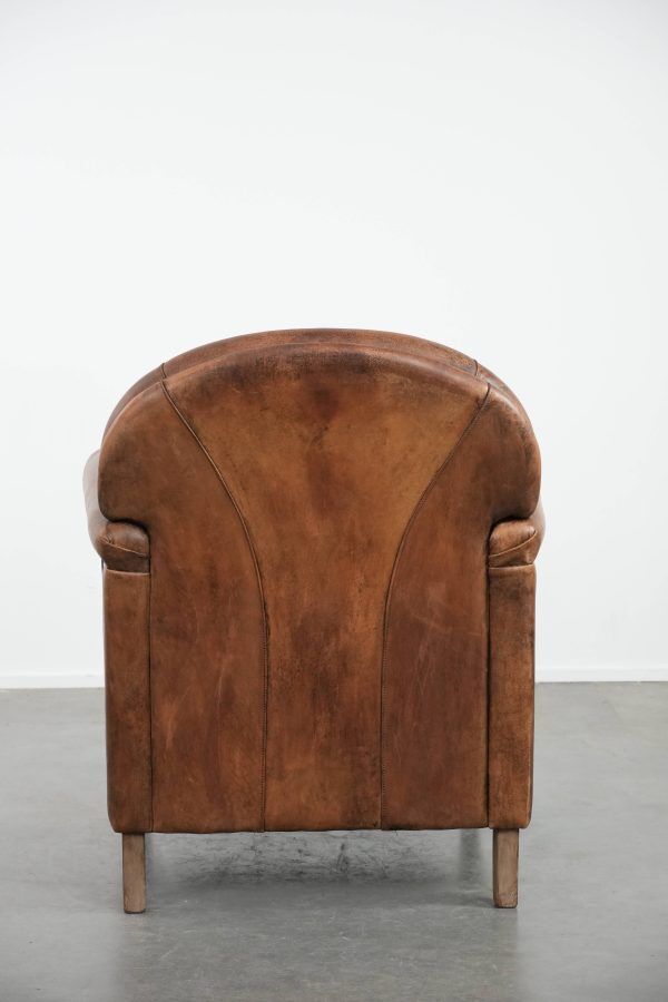 Beautiful vintage sheep leather armchair with a characterful appearance