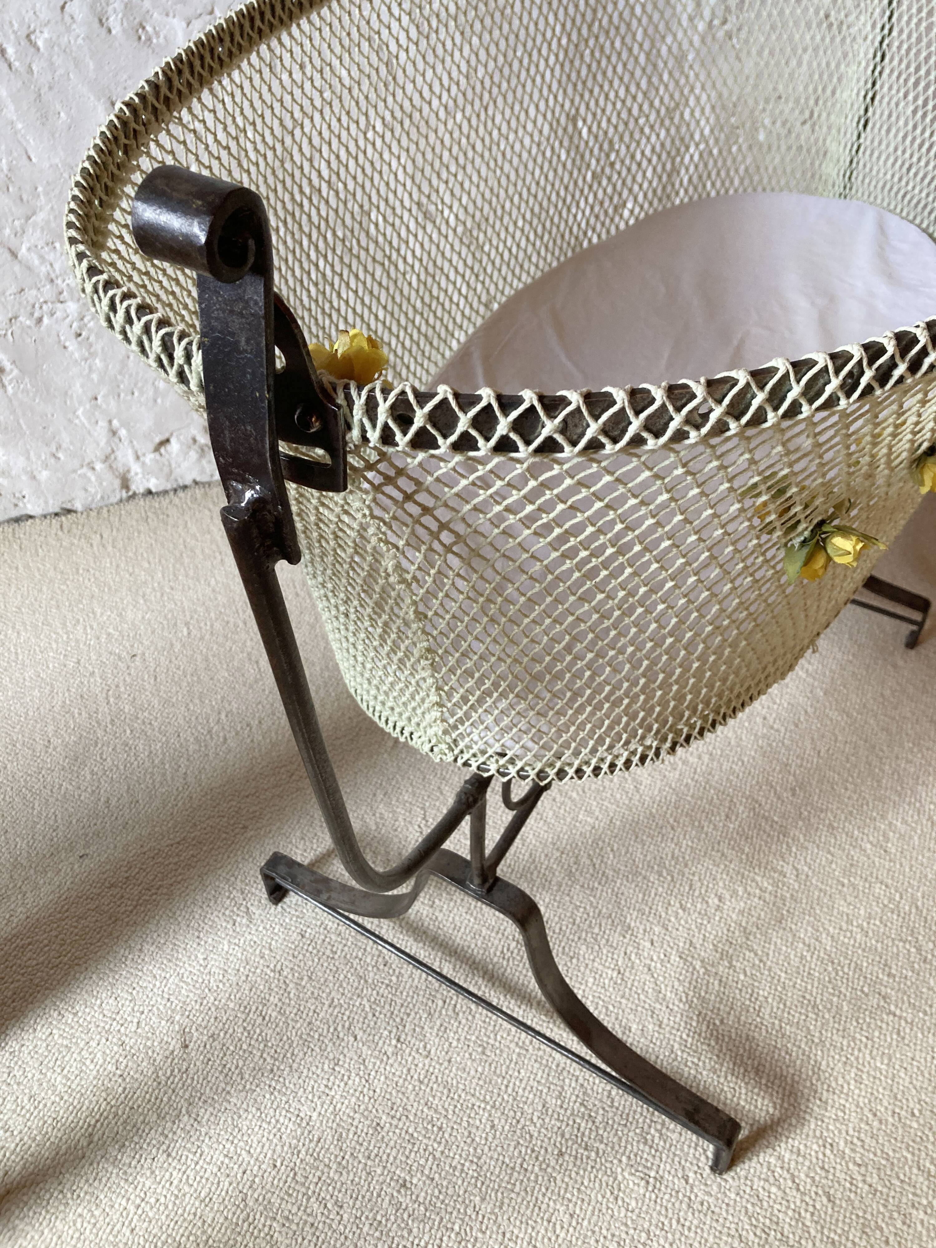 Antique rocking cradle in wrought iron