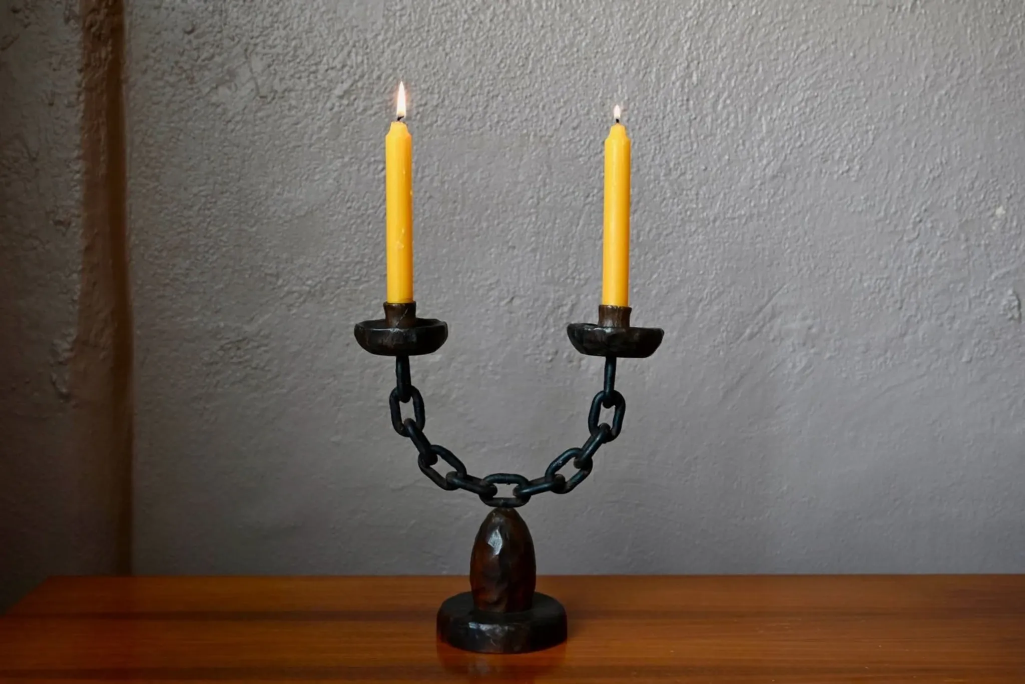Sculpted wooden and wrought iron brutalist double chandelier from the 1960s.