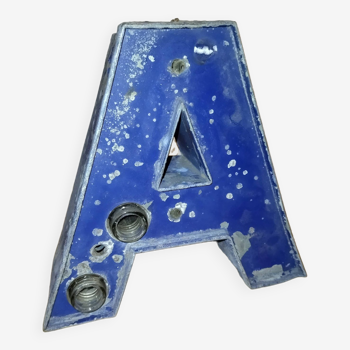 Old industrial letter in blue sheet metal illuminated commerce sign "a"