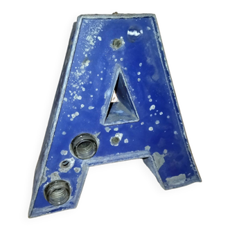 Old industrial letter in blue sheet metal illuminated commerce sign "a"