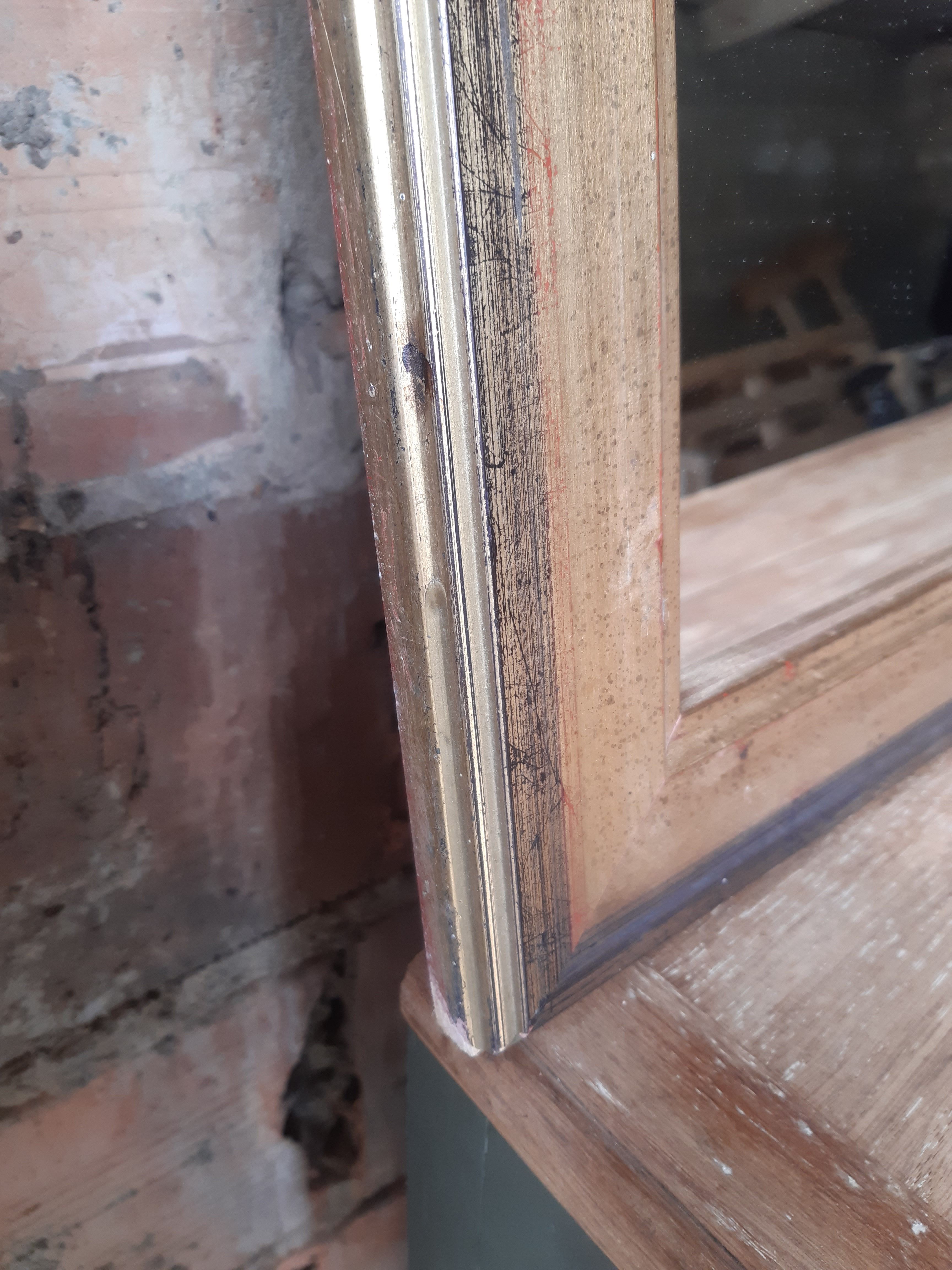 Old mirror of period handmade by cabinetmaking and decorated with gold leaf