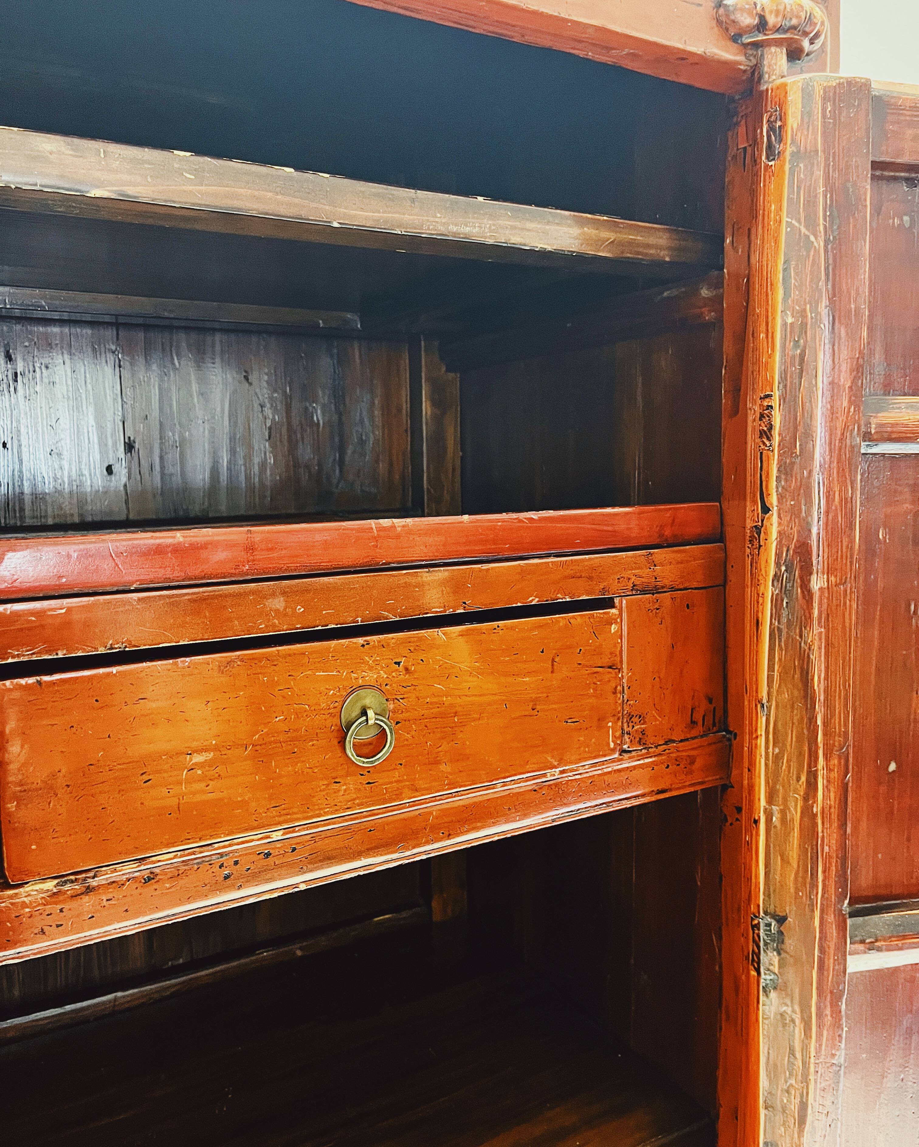 Antique red cabinet with brass details