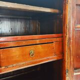 Antique red cabinet with brass details