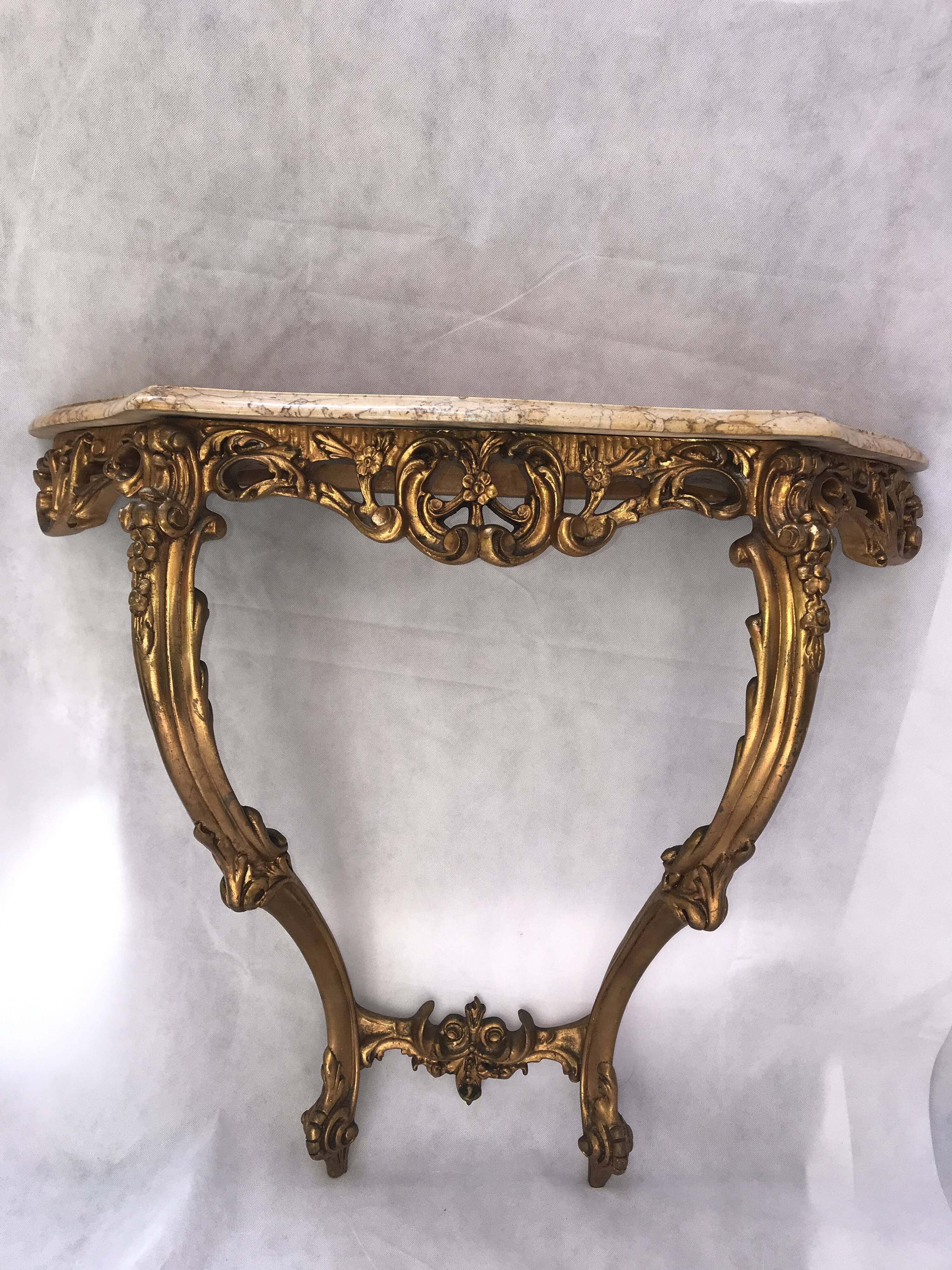 Golden console with marble in Louis XV style.