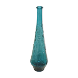 Blue pressed glass bottle decorated with flowers