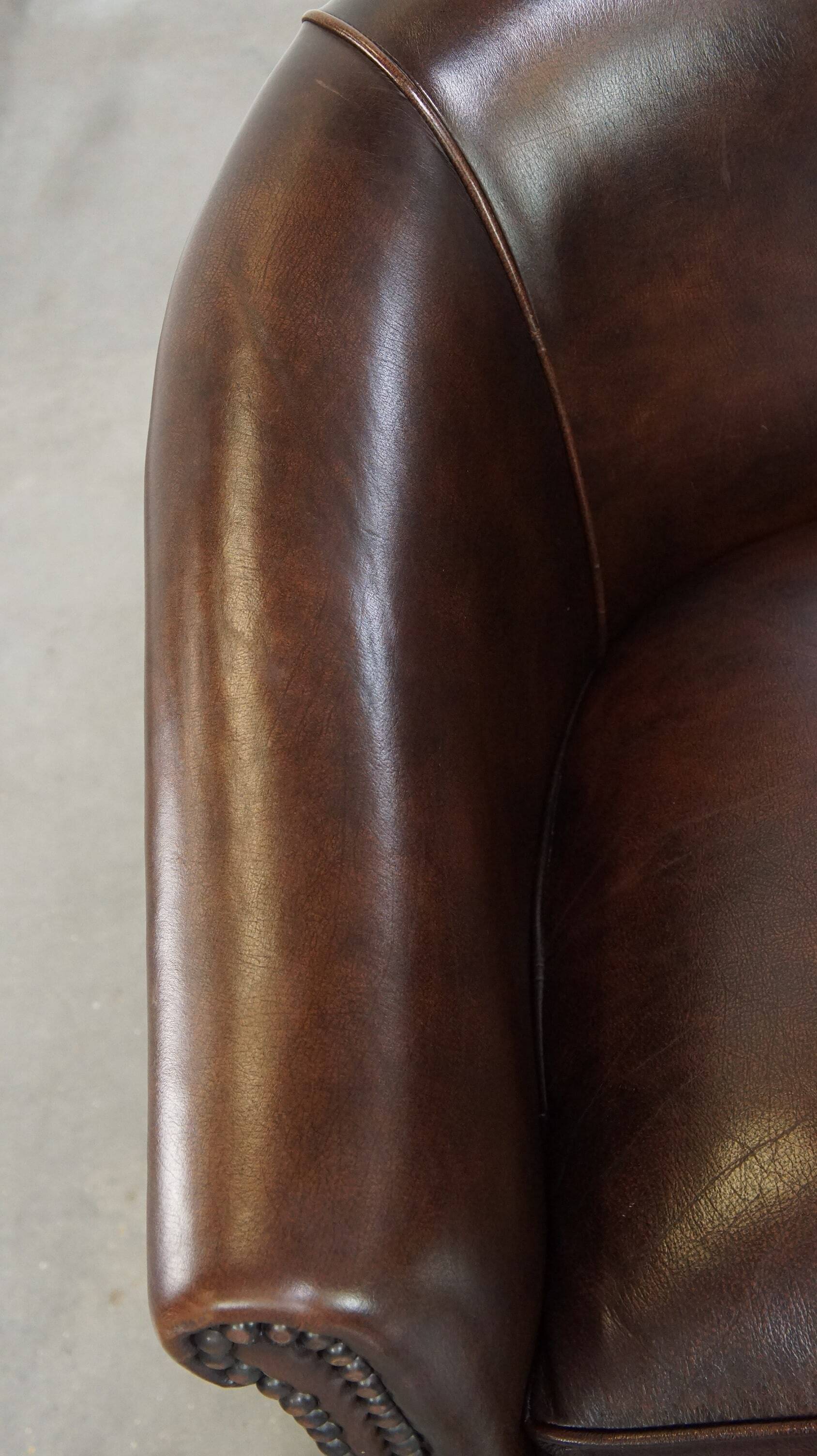 luxury dark leather club chair with English-style ball feet