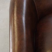 luxury dark leather club chair with English-style ball feet
