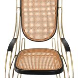 Modernist rocking chair in gilded brass and cane.