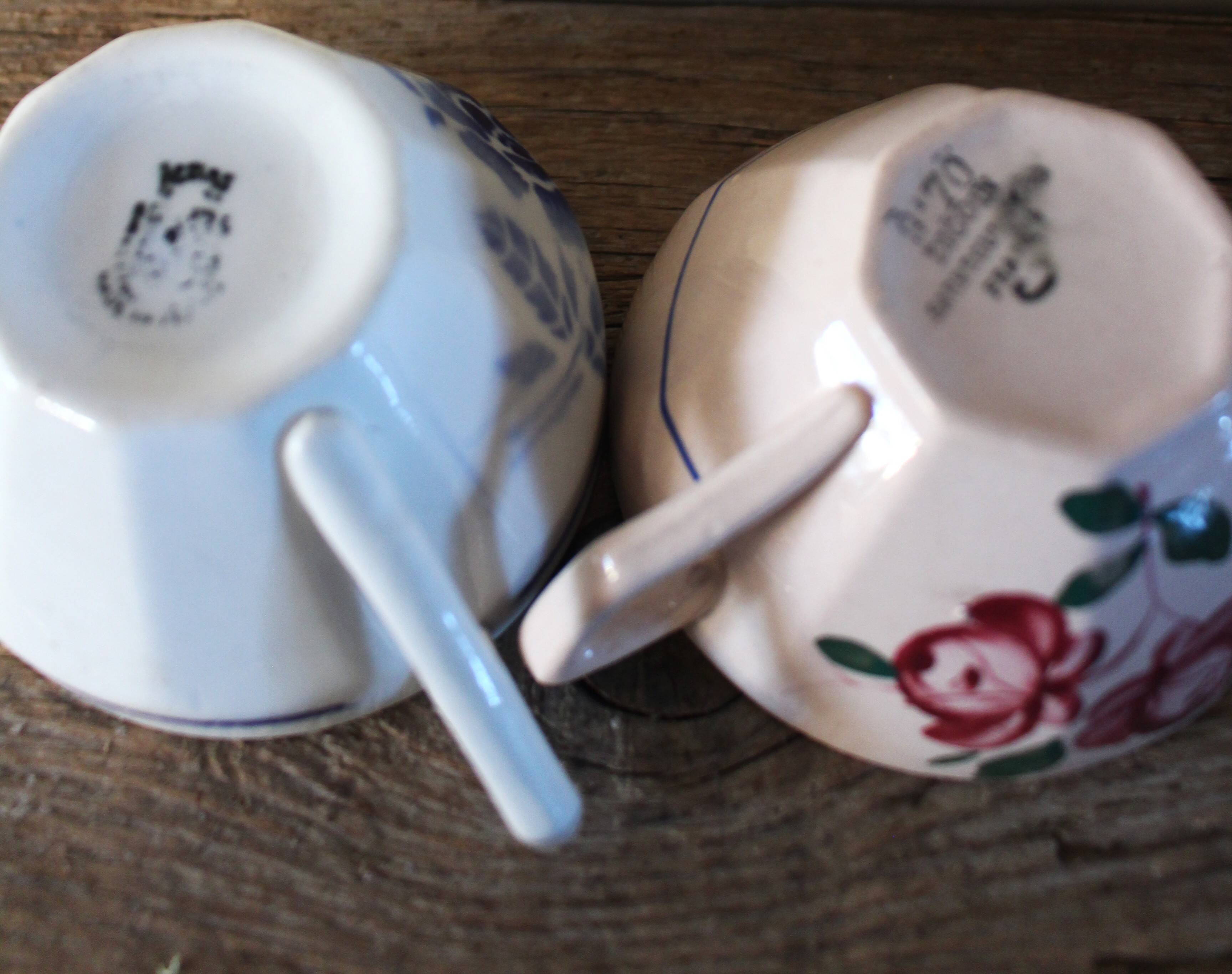 A set of 2 Digoin Sarreguemines cups with pink and blue flowers.