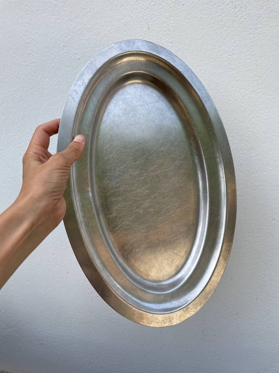 Oval stainless steel dish, signed Rémi Letang