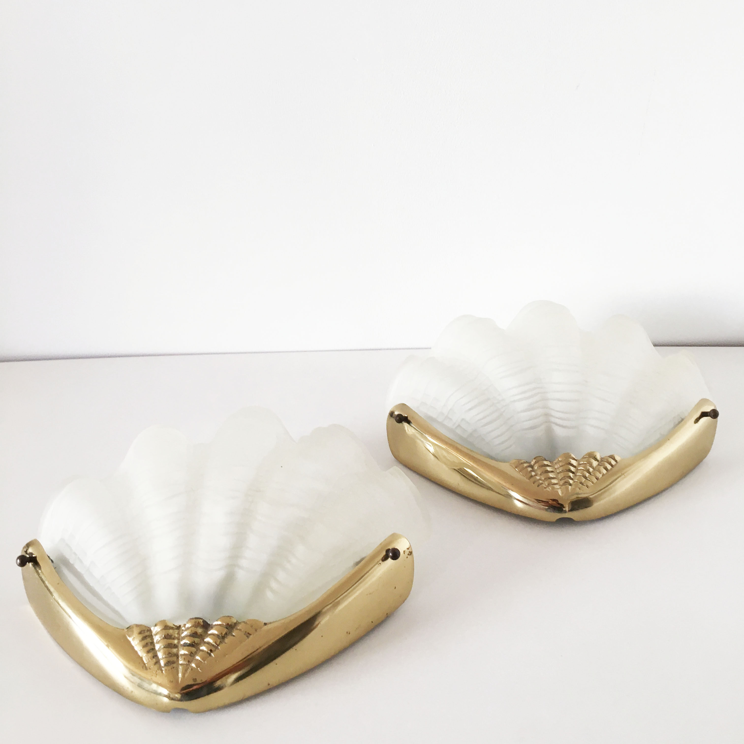 Pair of glass and gold metal shell sconces