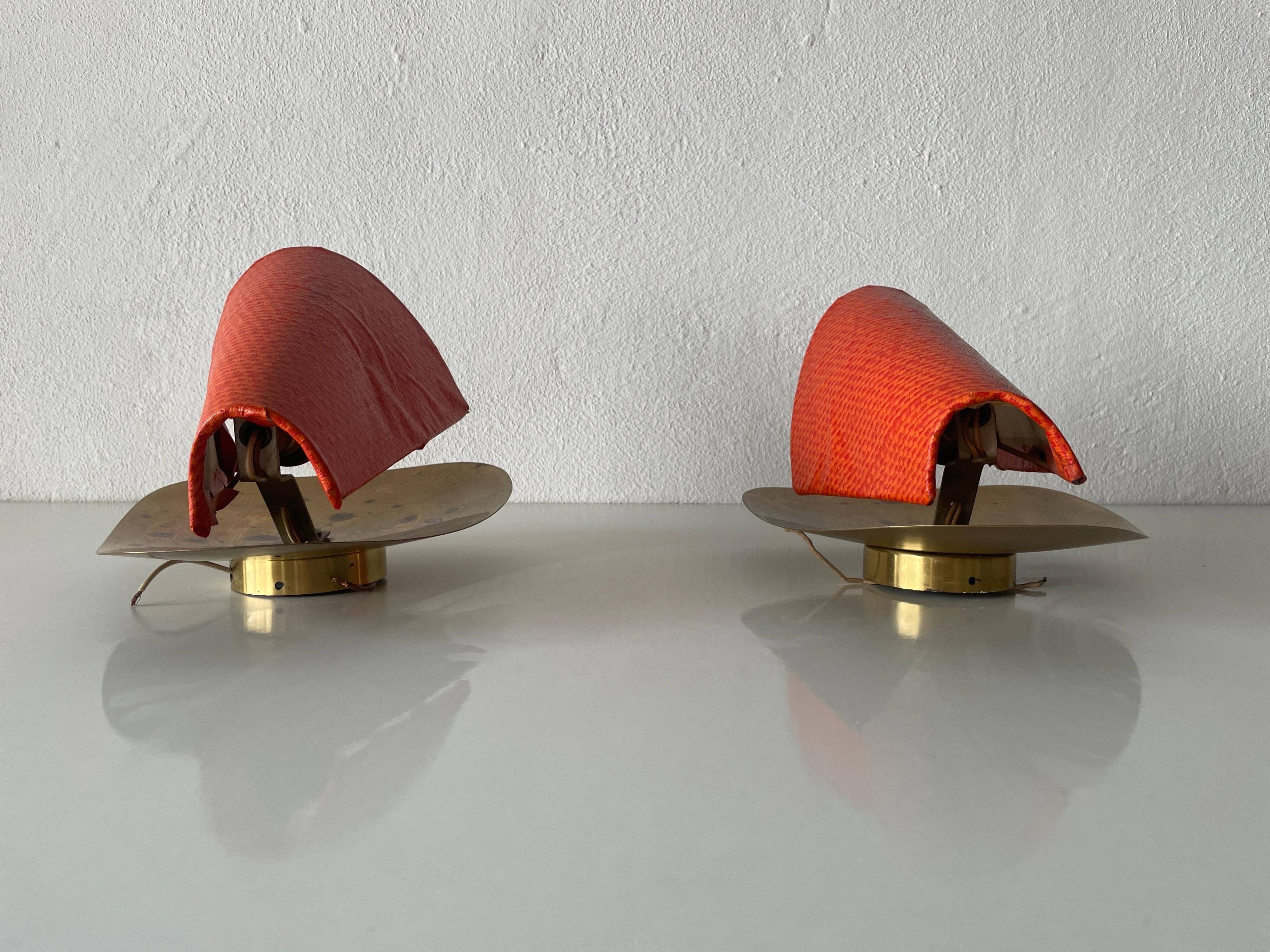 Pair of orange plexiglass and curved brass wall lights, 1950s, Germany