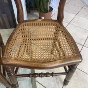 Pair of antique caned and wooden chairs from the 1900s.