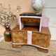 Art Deco bedside table in powder pink painted wood.
