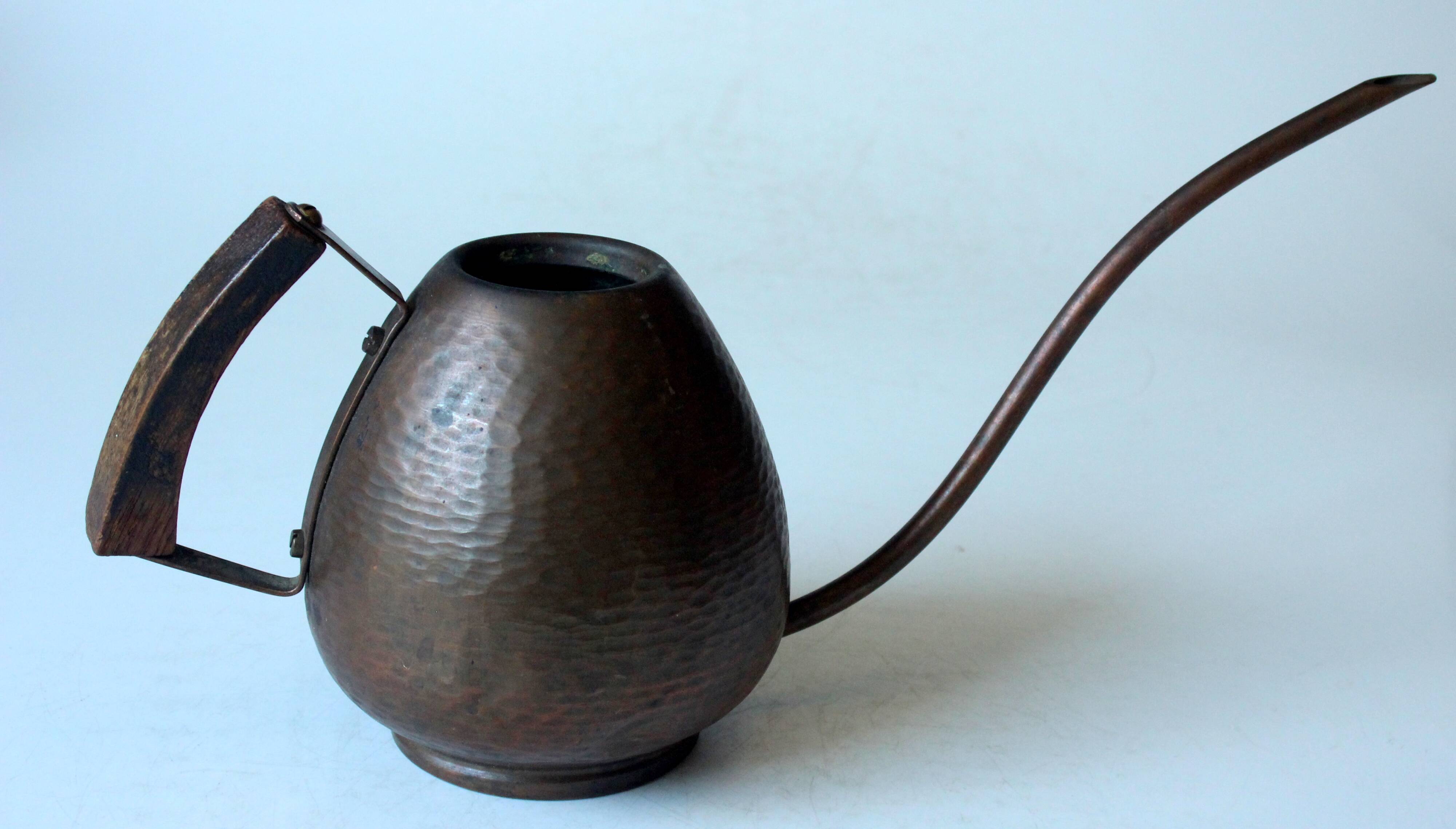 Old copper watering can with wooden handle, complete usuable, vintage from the 1960s