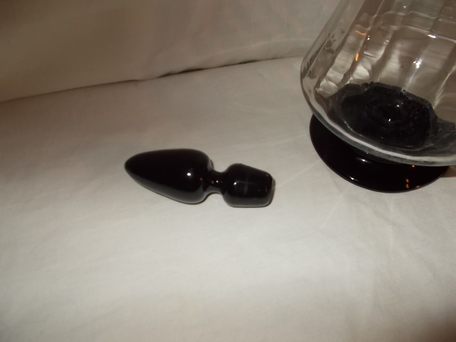 Dark purple glass wine carafe with a stopper.