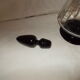 Dark purple glass wine carafe with a stopper.