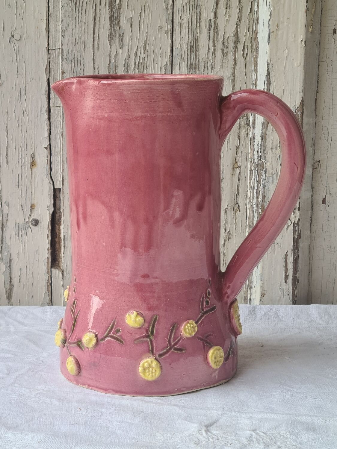 Glazed terracotta pitcher with mimosa decoration