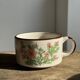 Small speckled stoneware cup made in Korea with a floral pattern H7 D11