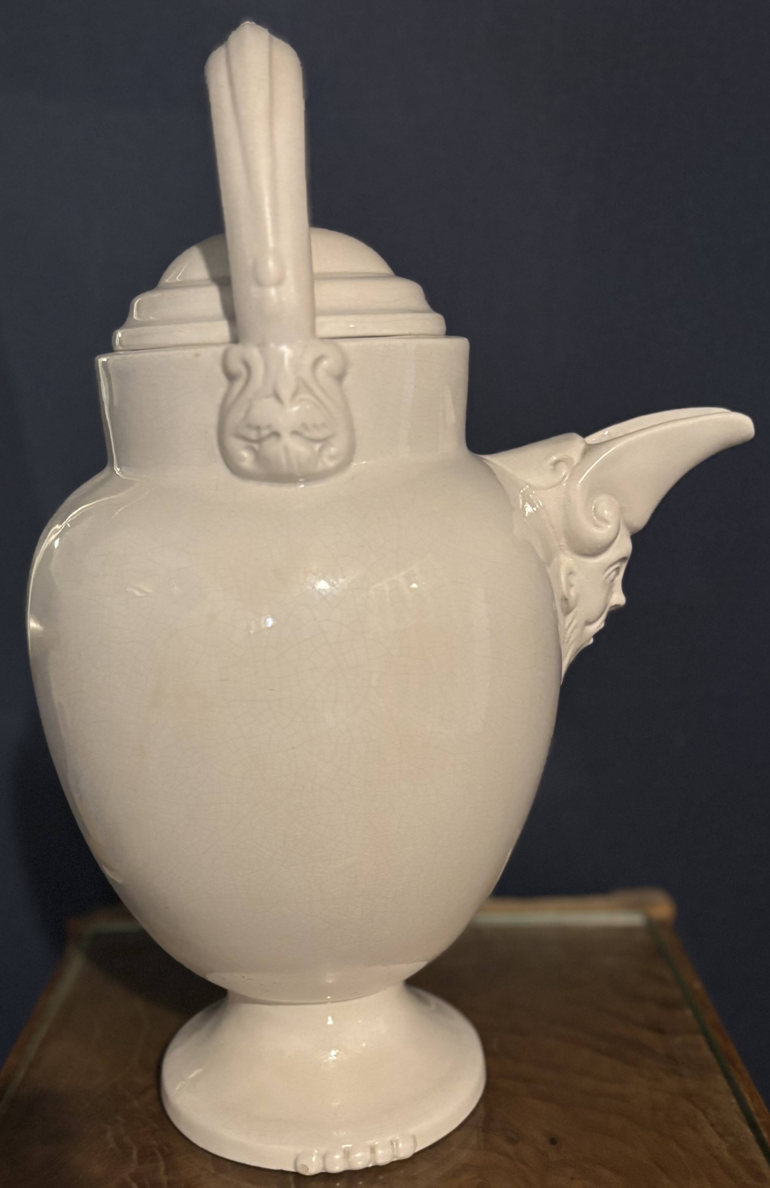 Large white faience jug with a satyr head spout, 19th century.