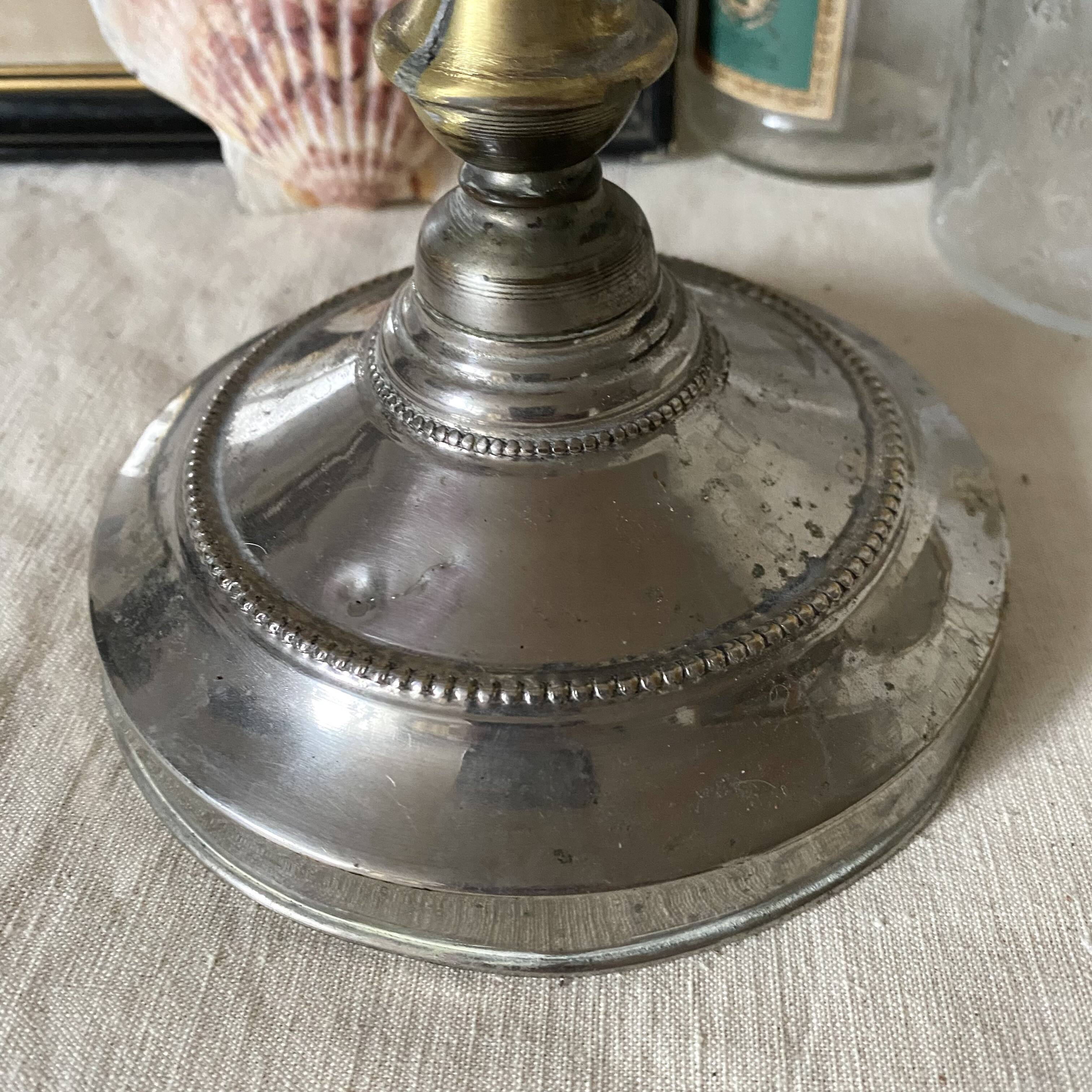 Antique jeweller's lamp, silver-plated base, frosted pink glass shade.