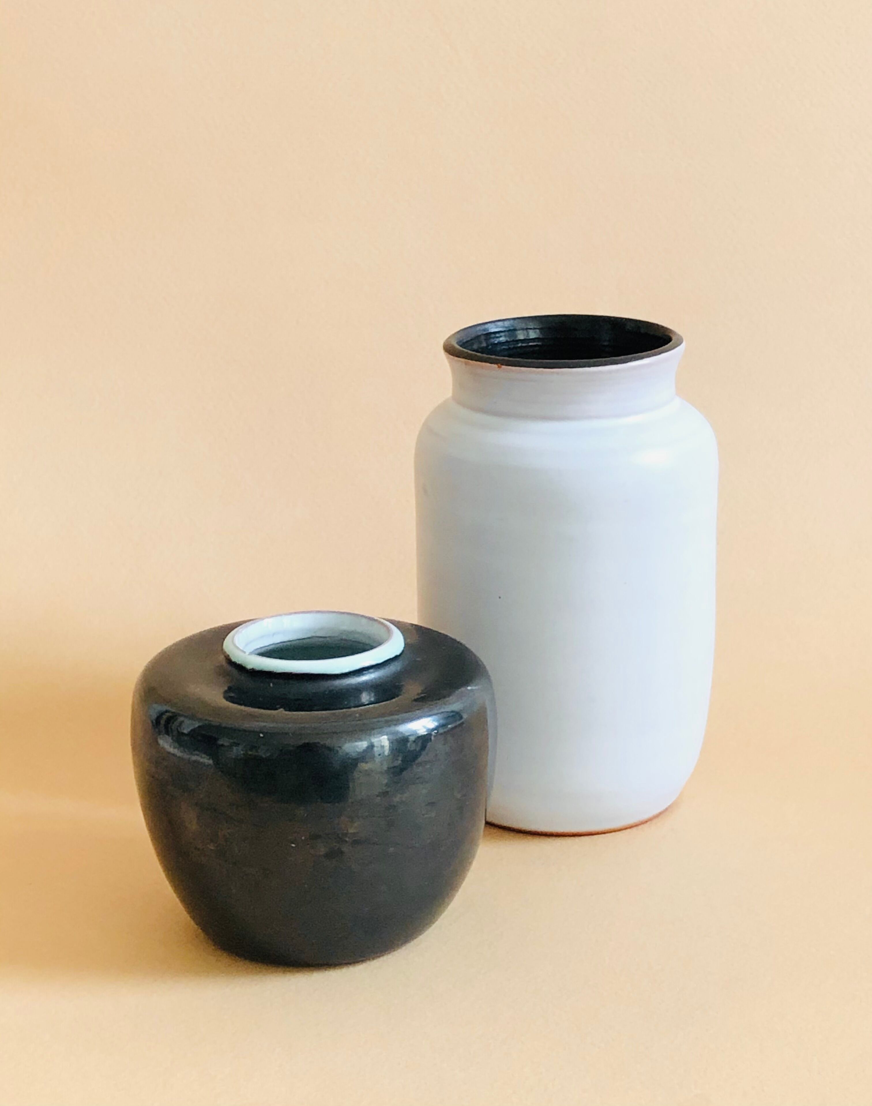Duo of small black and white ceramic vases