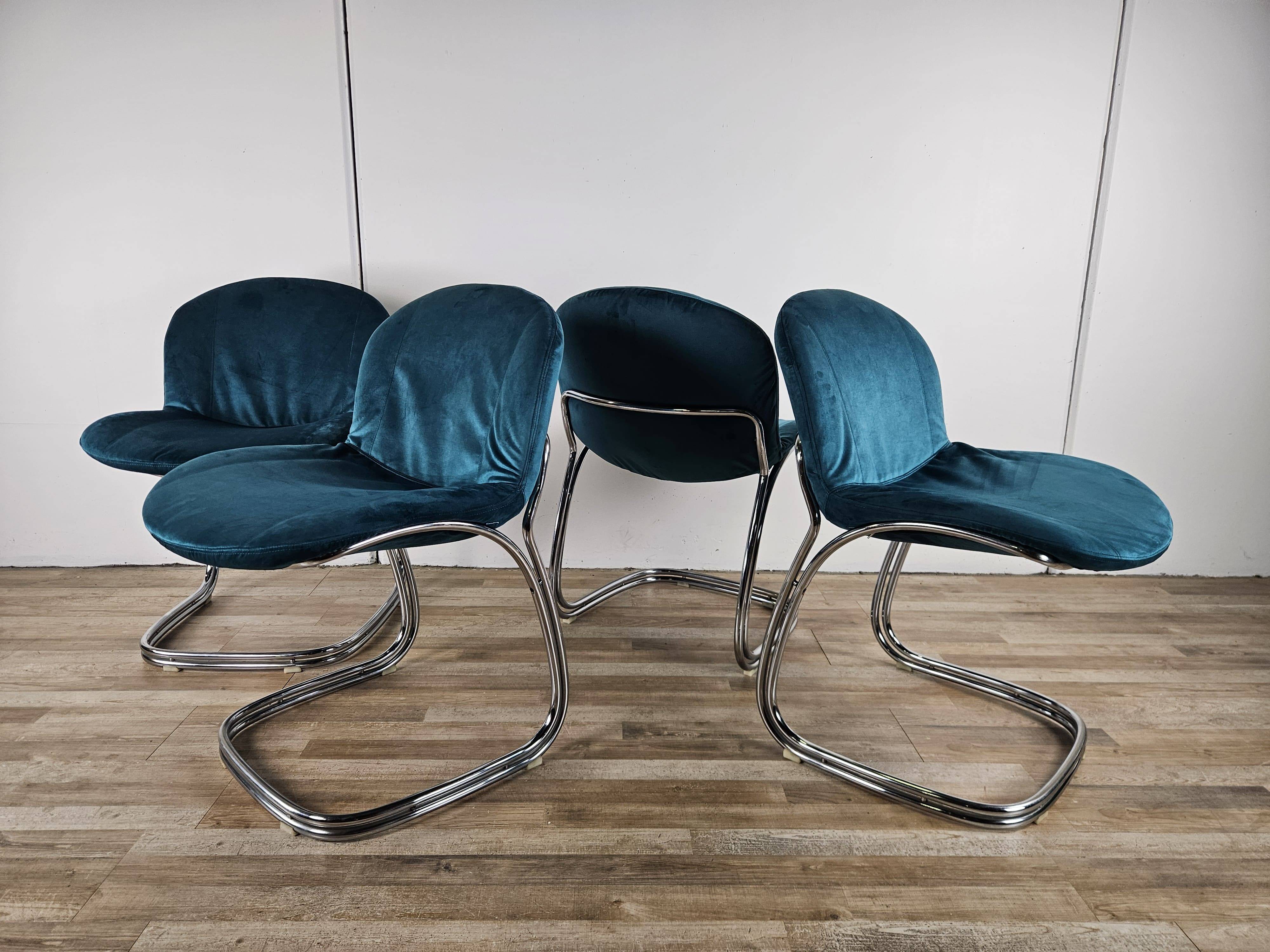 Four 1970s tubular chairs upholstered in blue velvet
