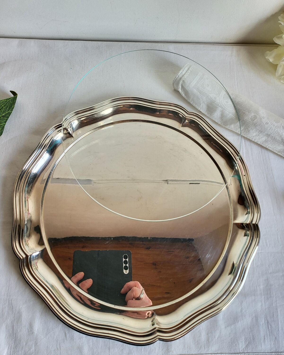 Round silver-plated serving dish with a glass base.