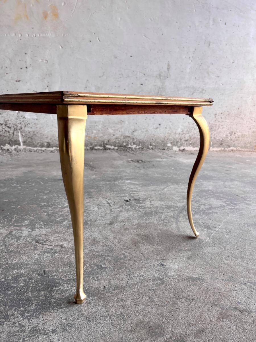 Vintage coffee table with gold-gilded legs and light brown wood veneer geometric inlaid top