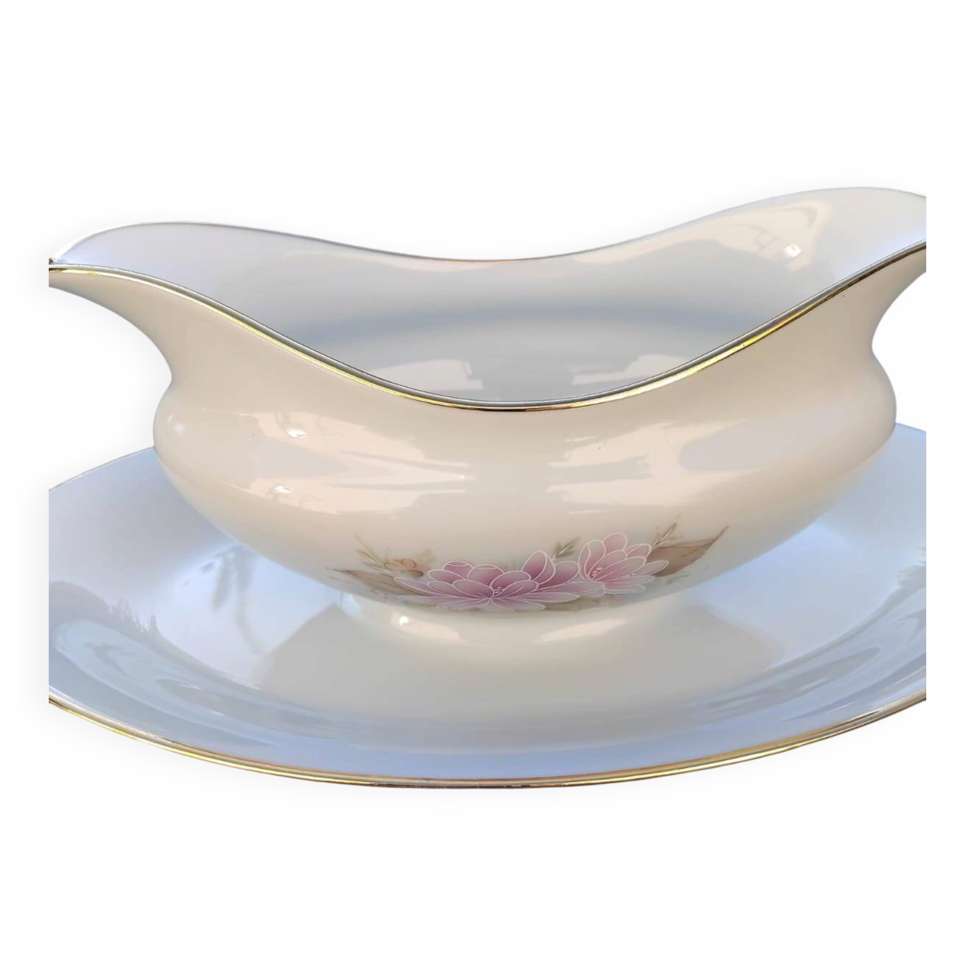 Vintage fine porcelain sauce boat with gold gilding.