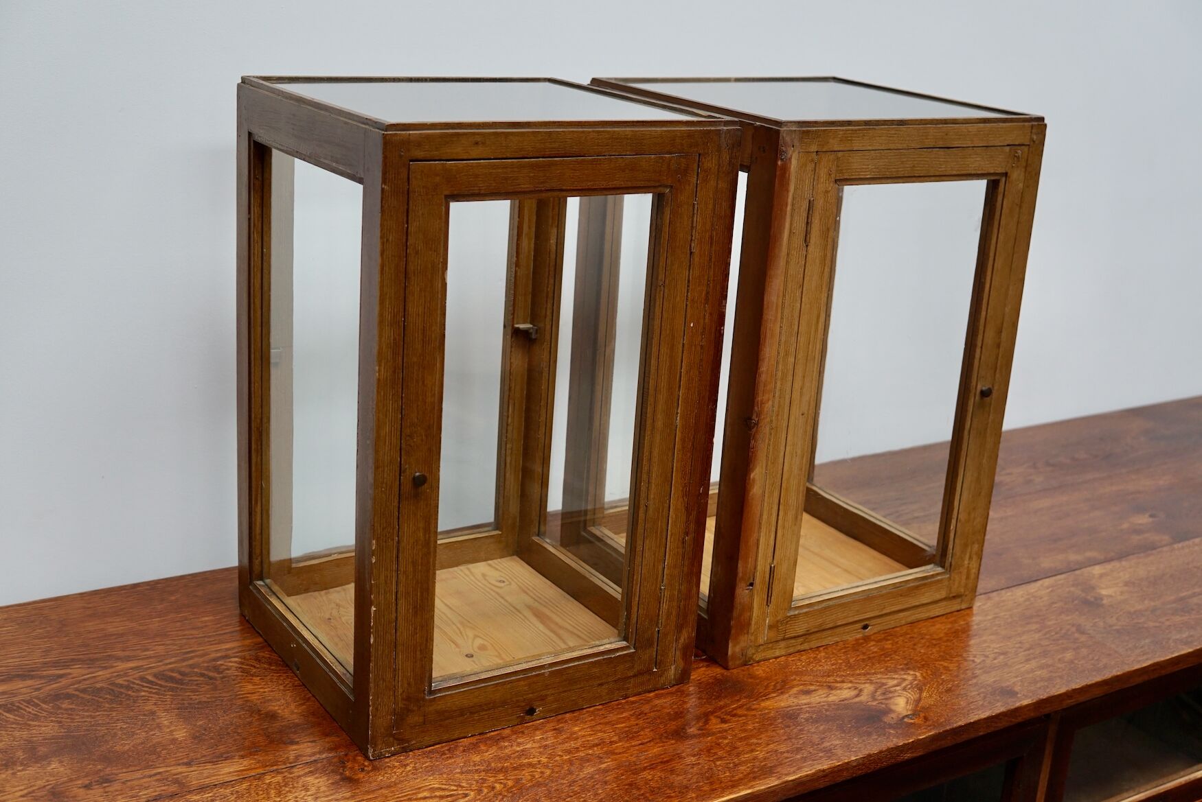 pair of faux oak shop display cabinets, circa 1920s
