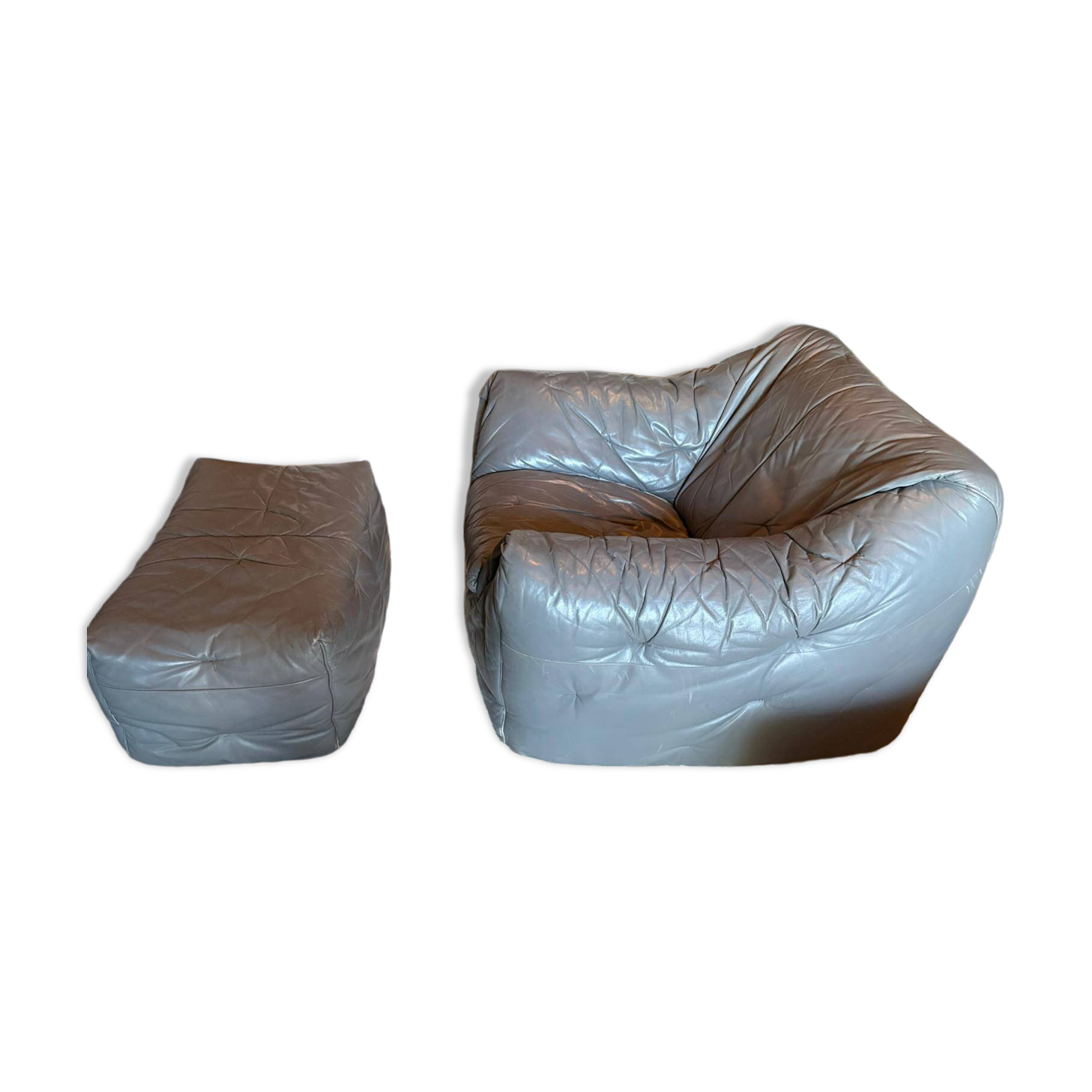 Sloop armchair and pouf from Ligne Roset in grey leather.