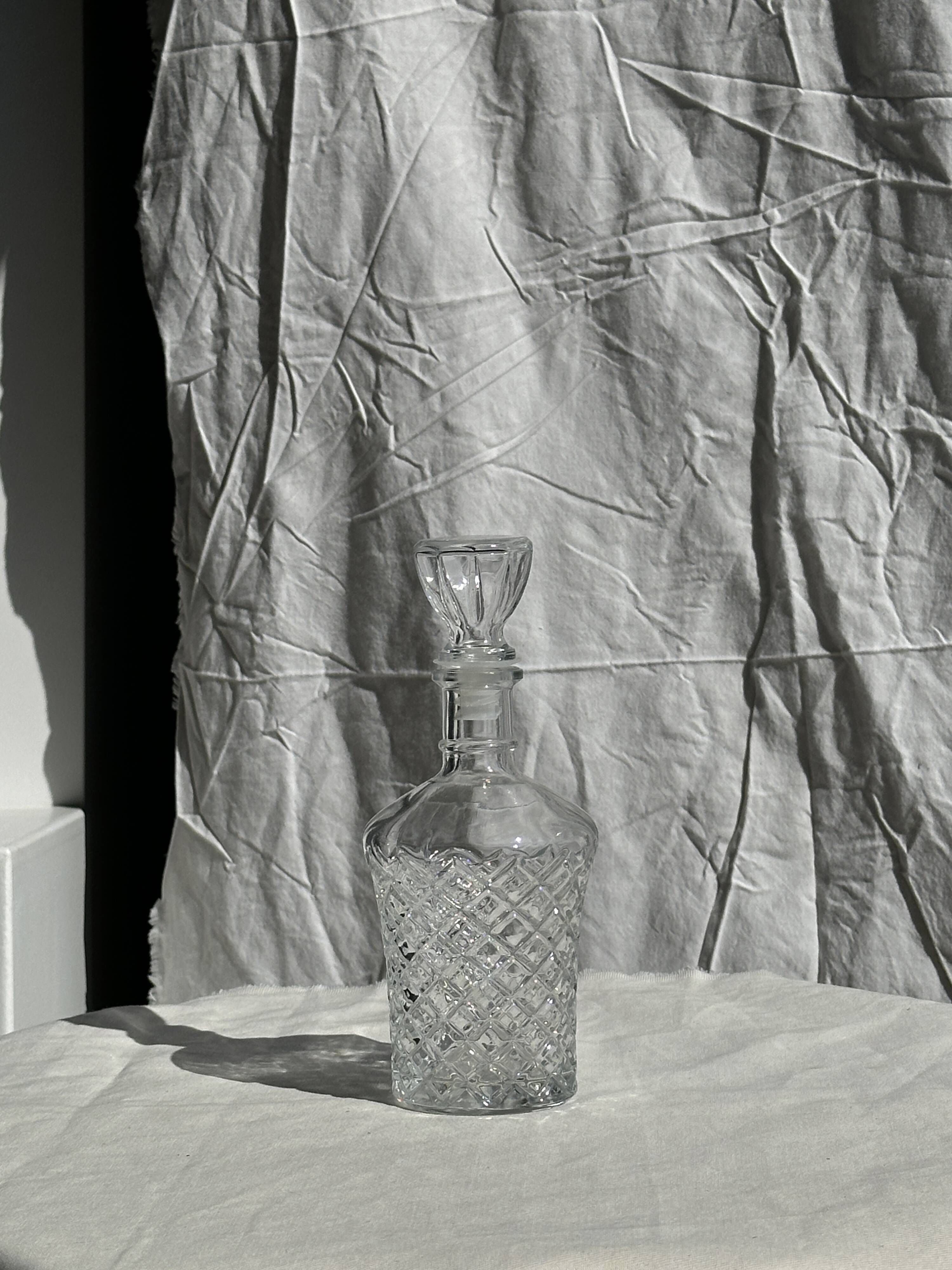 Small cylindrical glass whiskey decanter H:23