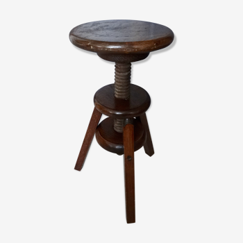 Old wooden stool has adjustable screw