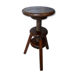 Old wooden stool has adjustable screw