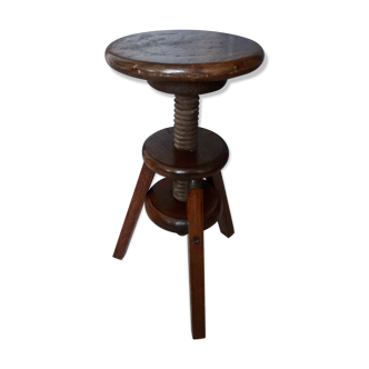 Old wooden stool has adjustable screw
