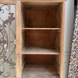 Column storage unit with a sculpted metal door.