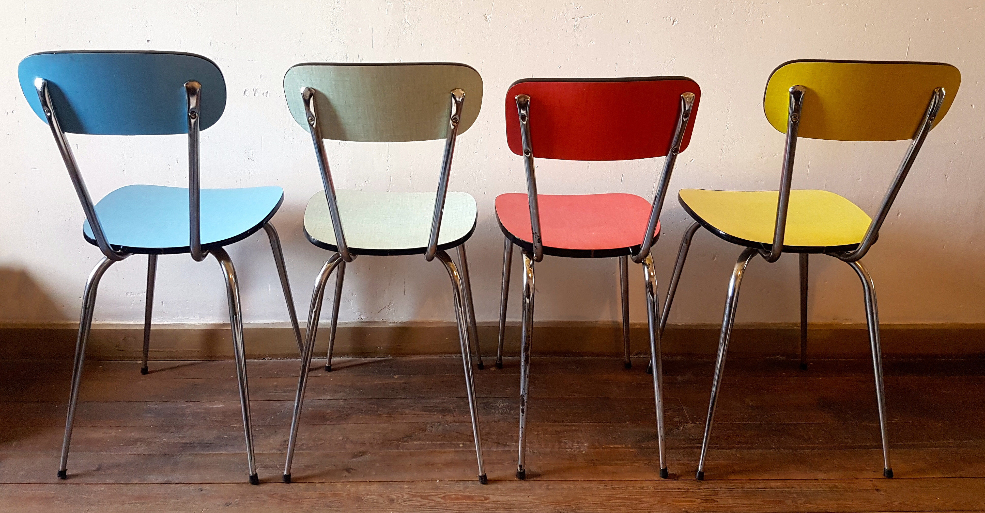 Four formica chairs in different colors