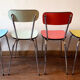 Four formica chairs in different colors