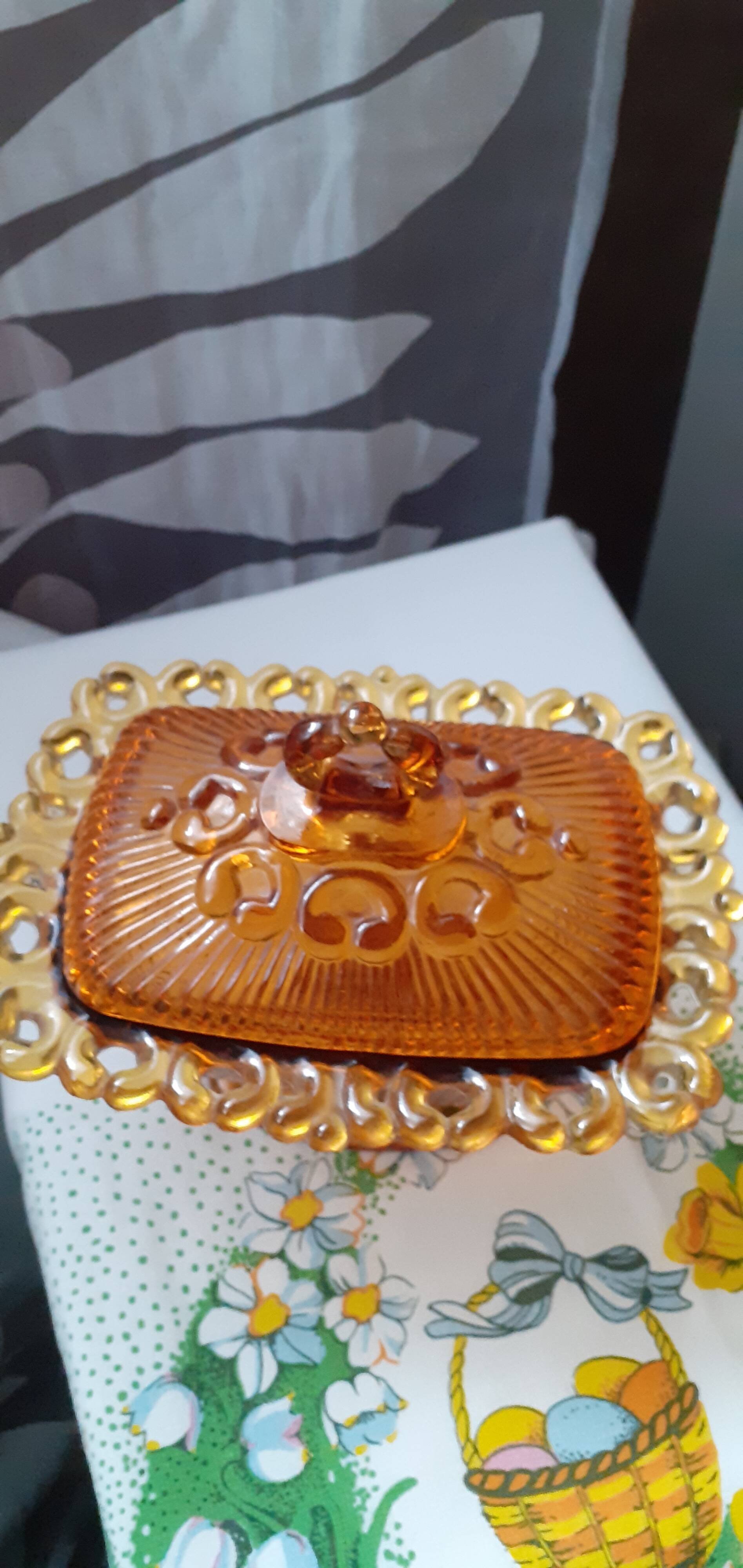 amber-colored pressed glass butter dish