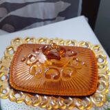 amber-colored pressed glass butter dish