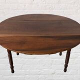 Oval walnut table with flaps